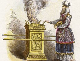 Priest making an offering at the temple.